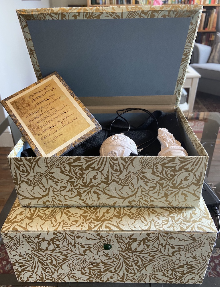 Image showing a box containing replicas of devotional items that are readable by near field communications.